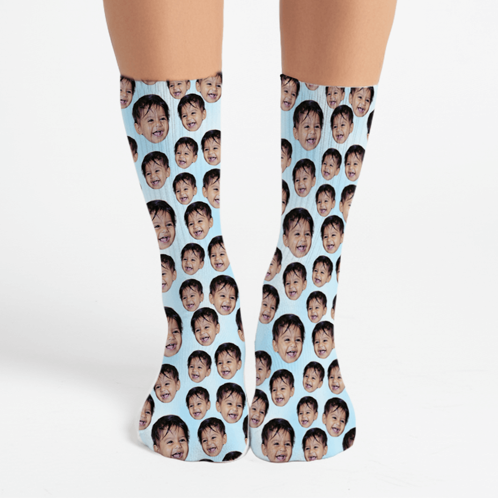 Socks with a pattern of a child's face on a light blue background