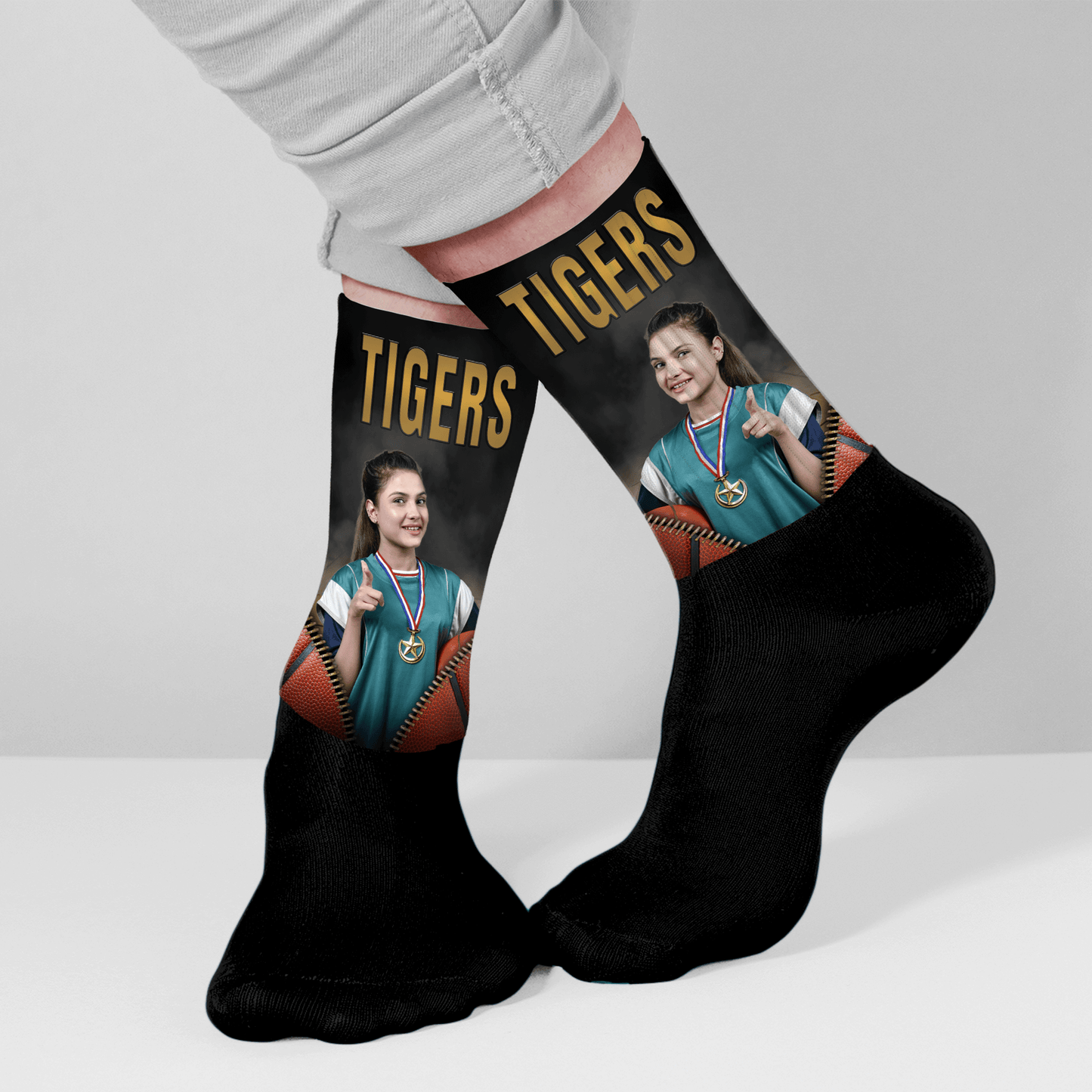 Black socks with team name and sports-themed design worn by a person.