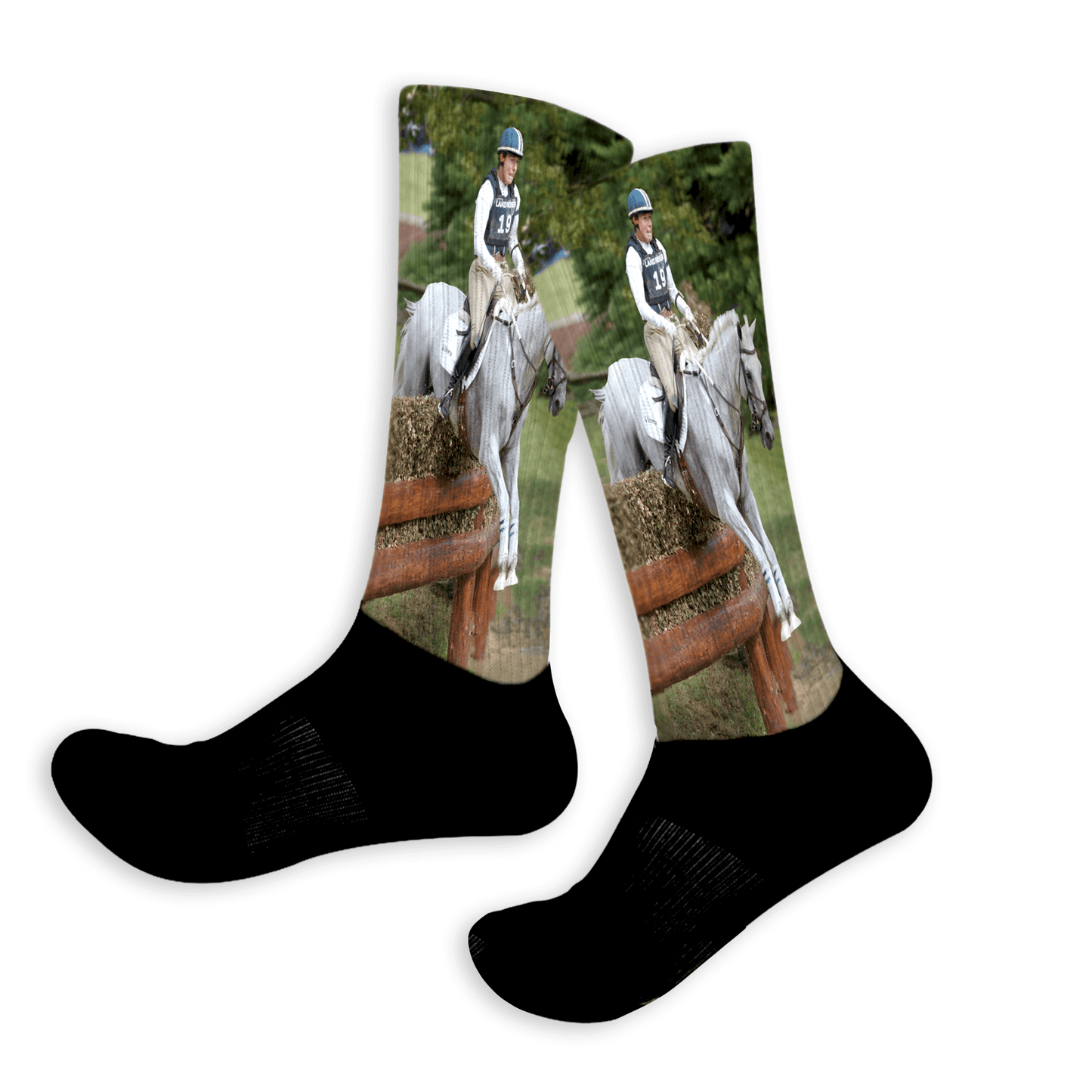 Socks with equestrian design featuring a rider on a horse jumping over an obstacle.
