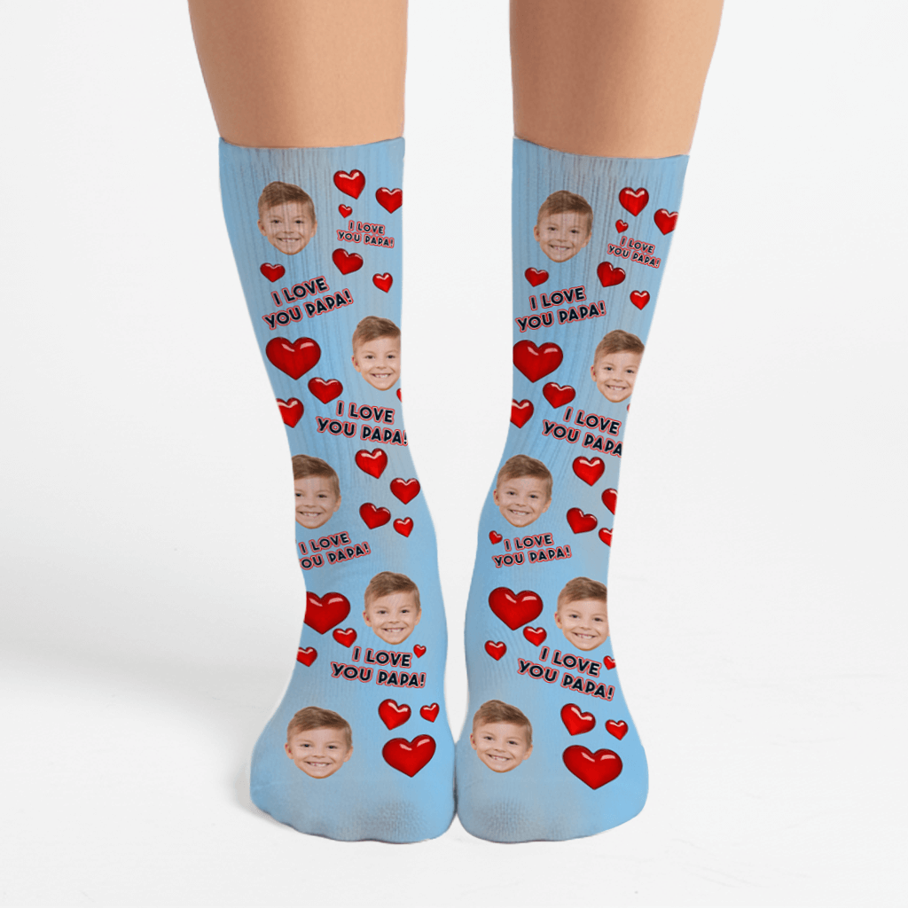 Blue socks with red hearts and a child's face, text 'I Love You Papa' on a white background