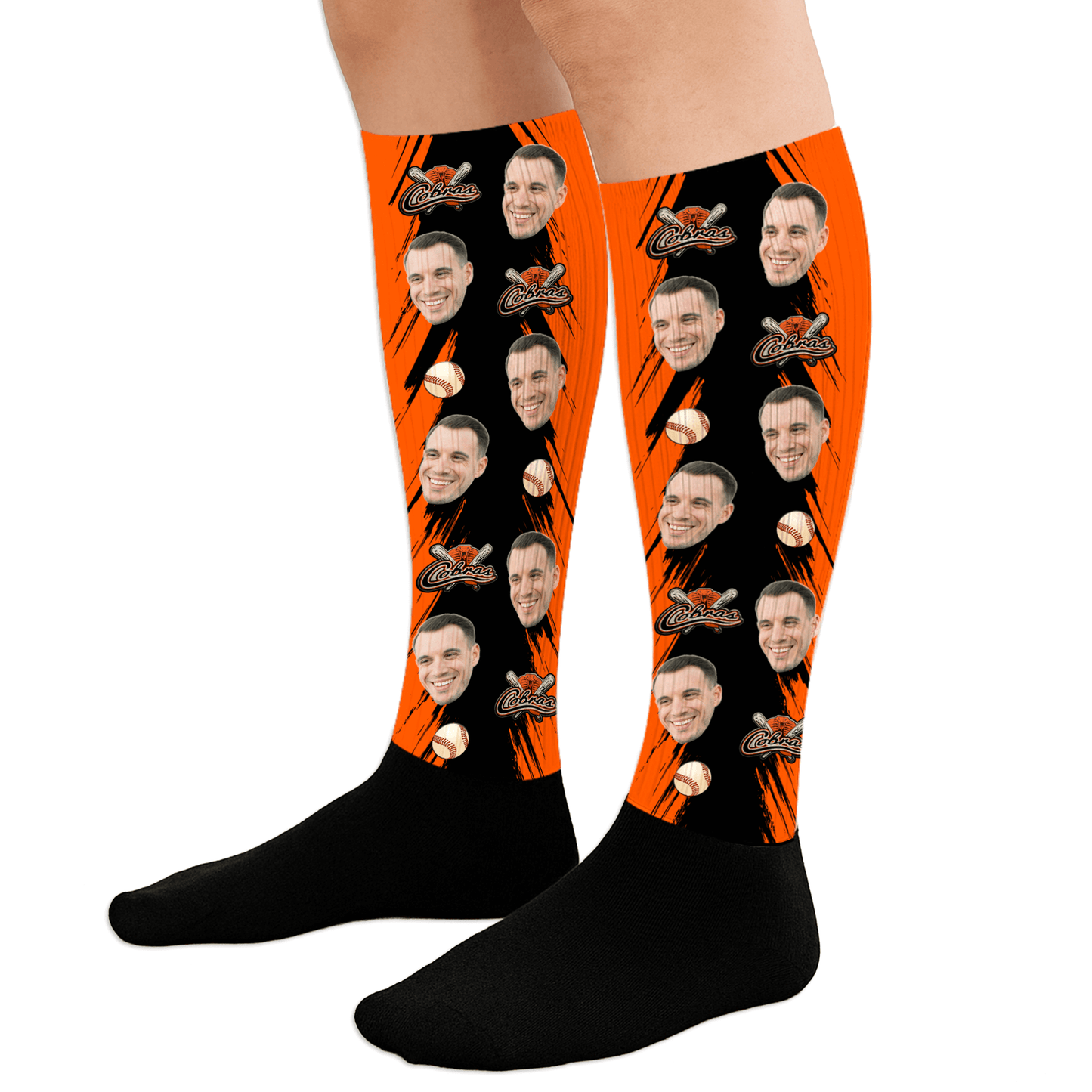 Black and orange socks with a face printed design on a white background