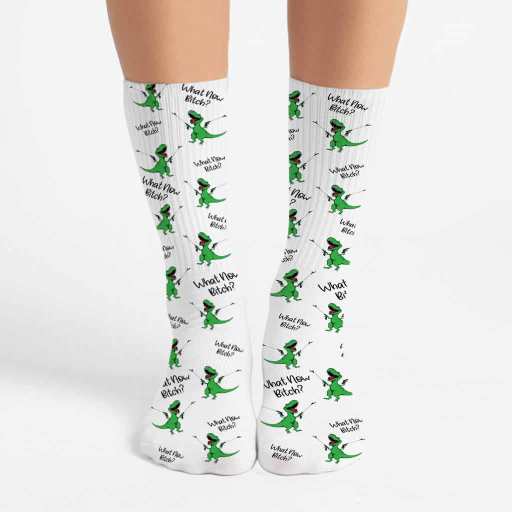 Funny green dinosaur crew socks with “What Now Bitch?” quote. Sassy gift for friends, white elephant, or office exchanges.