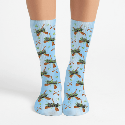 Light blue socks with a funny shit creek survivor design. Great snarky gift idea