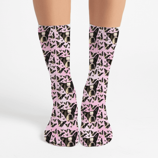 Socks with a pattern of dogs and pink bows on a white background