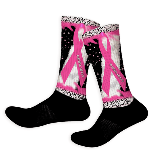 Black socks with pink and white designs and 'Resilient' text on a white background