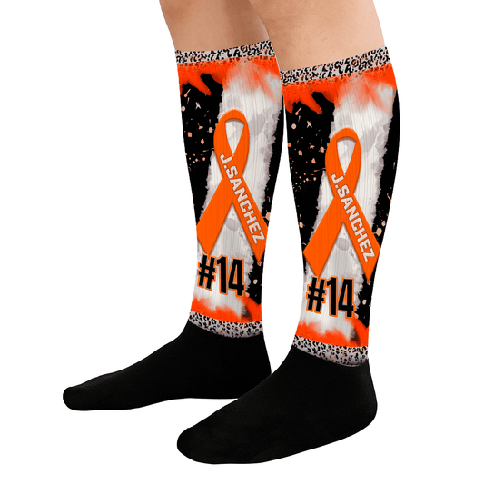 Knee-high socks with orange ribbon design, black text, and white pattern on a white background