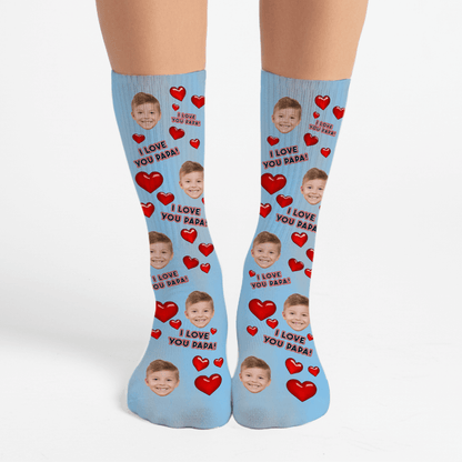 Blue socks with red hearts and a child's face, text 'I Love You Papa' on a white background