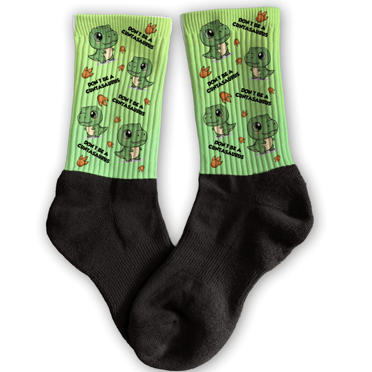 Funny dinosaur crew socks with “Don’t Be a Cuntasaurus” graphic, bold adult attitude gift.