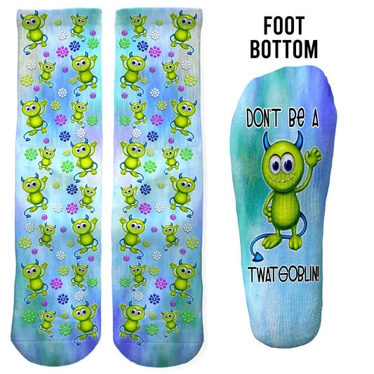 Green cartoon monster crew socks with “Don’t Be a Twatgoblin” on the foot bottom. Funny gag gift for birthdays, white elephant, or office parties.