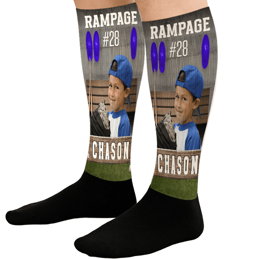 Custom socks with a graphic of a person in a blue cap and white shirt, with text and numbers on a black background.