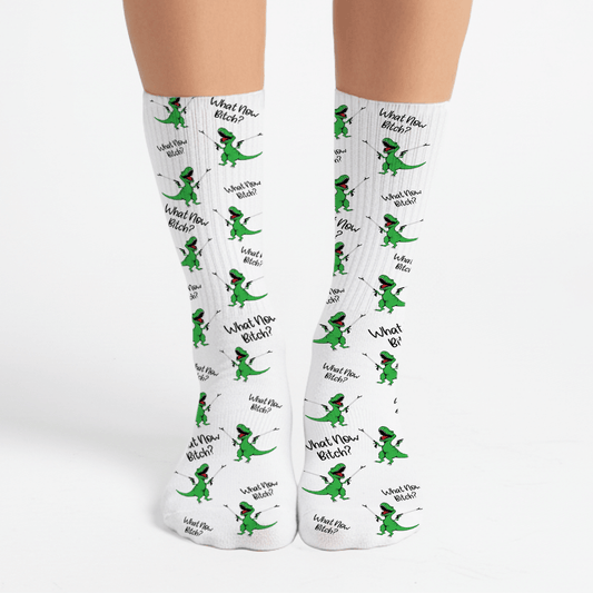 Funny green dinosaur crew socks with “What Now Bitch?” quote. Sassy gift for friends, white elephant, or office exchanges.